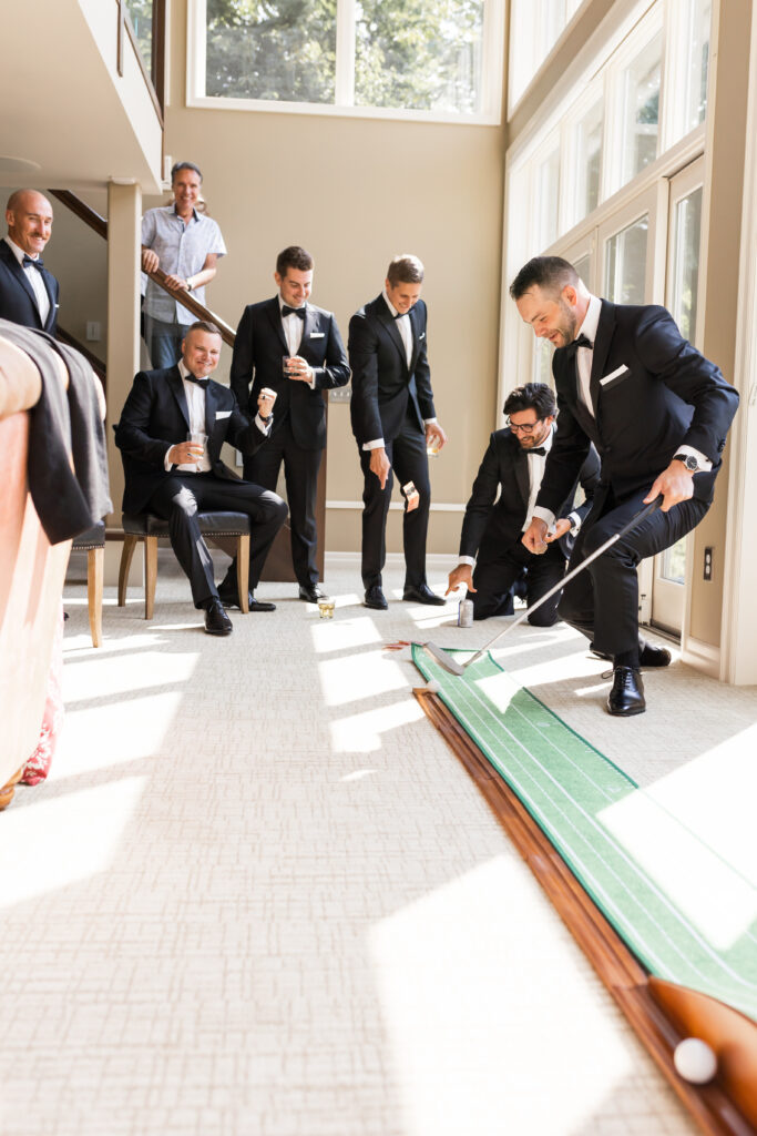 groomsmen playing indoor gold on wedding day 