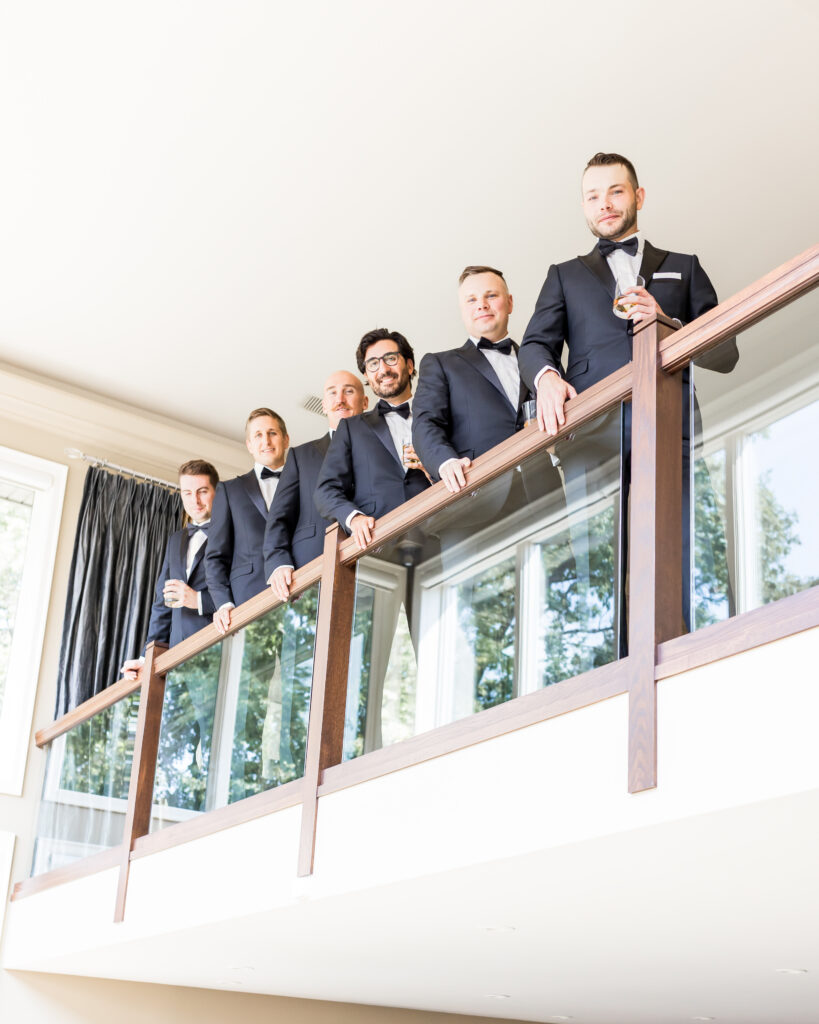 groomsmen standing over indoor balcony 