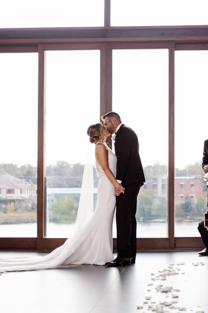 couple having first kiss at wedding at the cambridge mill