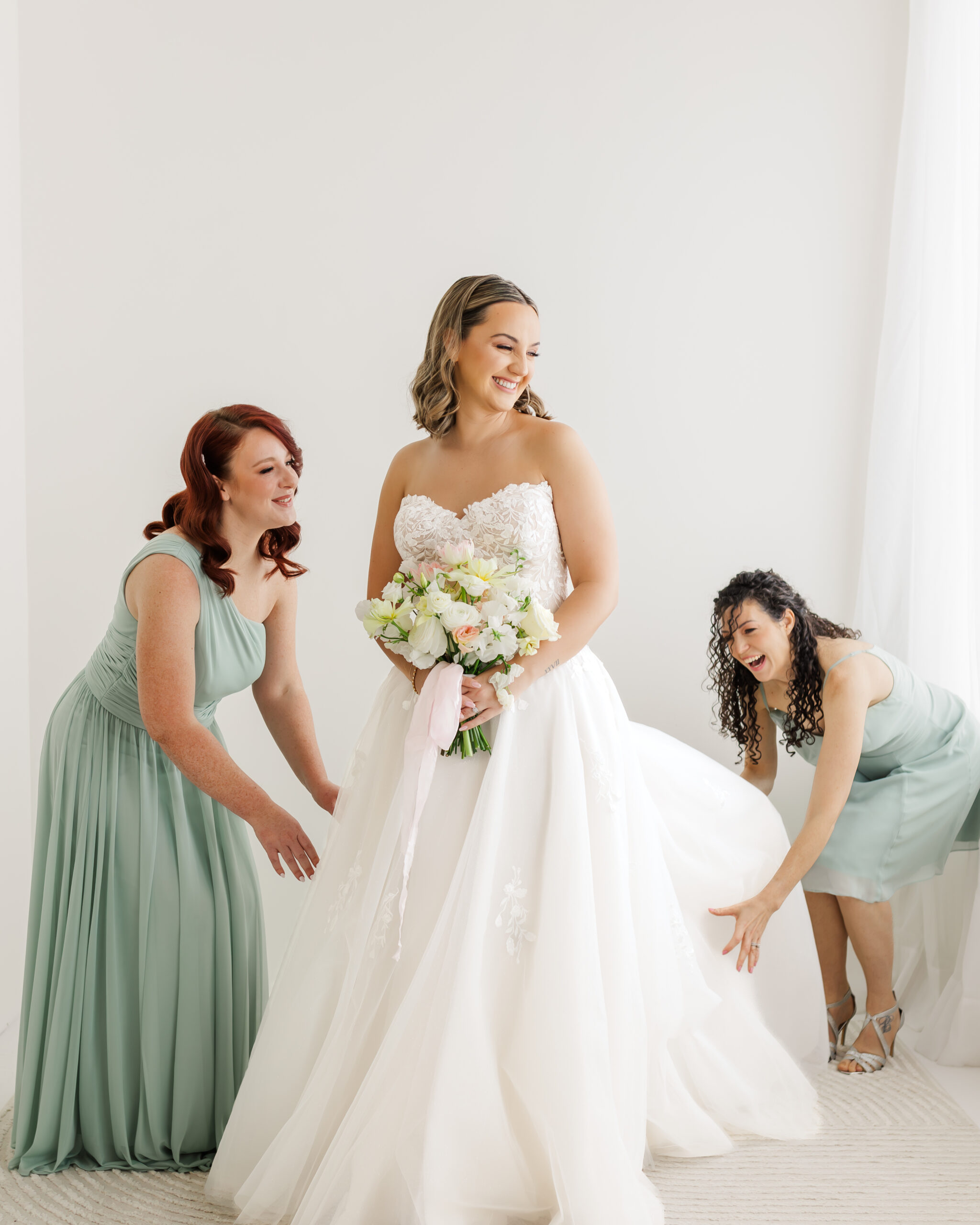 bride and bridesmaids having fun cambridge mill weddings