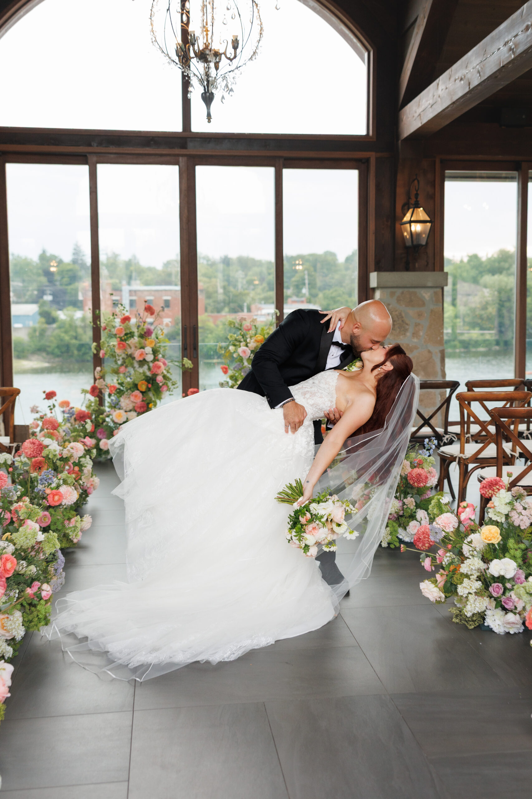 couple kissing in the cambridge mill ceremony pavillion