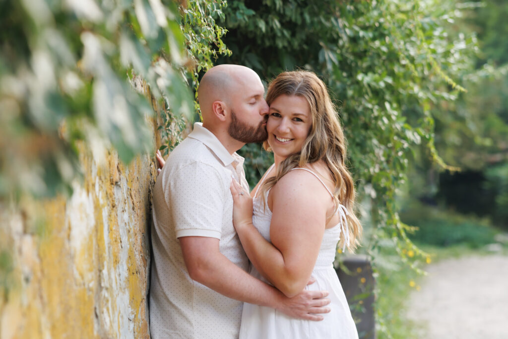 Couple laughing during engagement session at Elora Mill, Ontario.