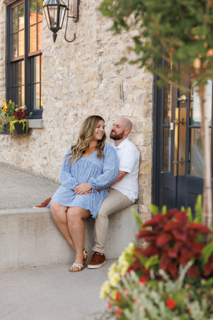 Romantic engagement photos in front of Elora Mill stone wall.