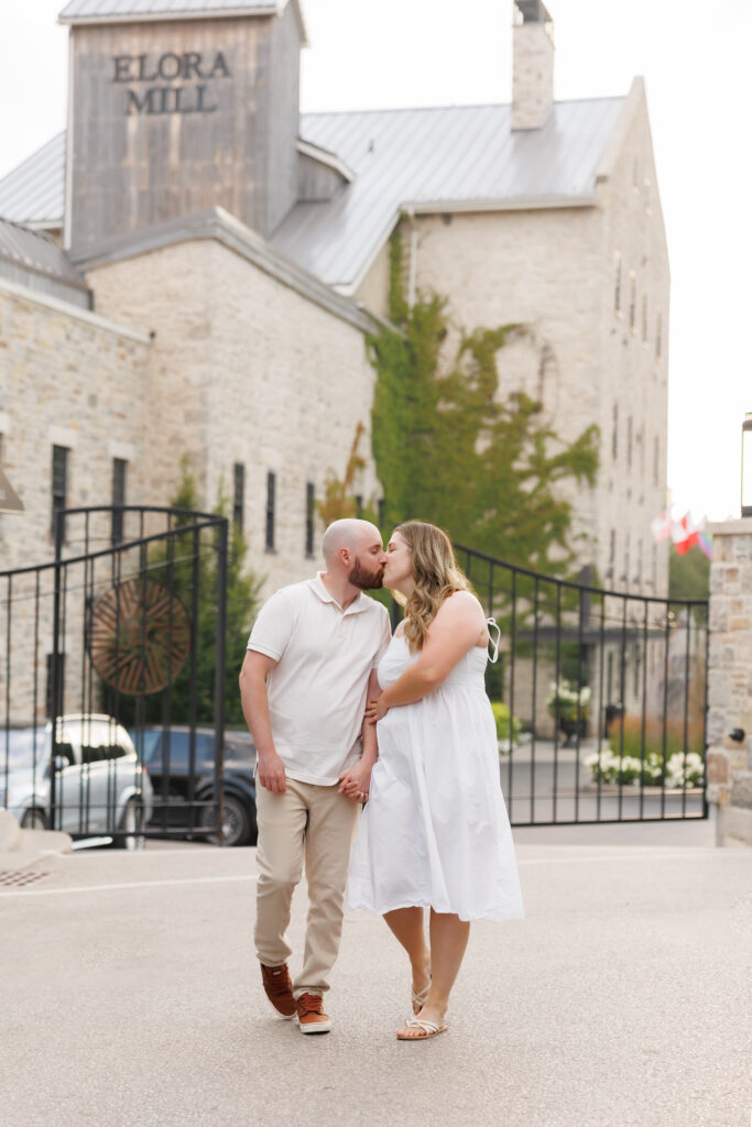 Engagement photos in front of Elora Mill stone walls