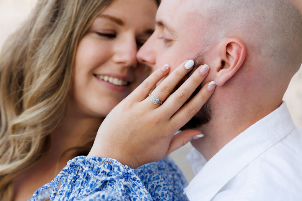 Couple holding each other during engagement session at Elora Mill