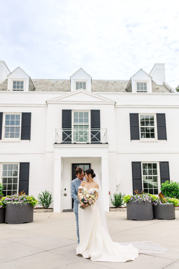 Bride and groom in front of Harding Waterfront Estate, Mississauga wedding venue.