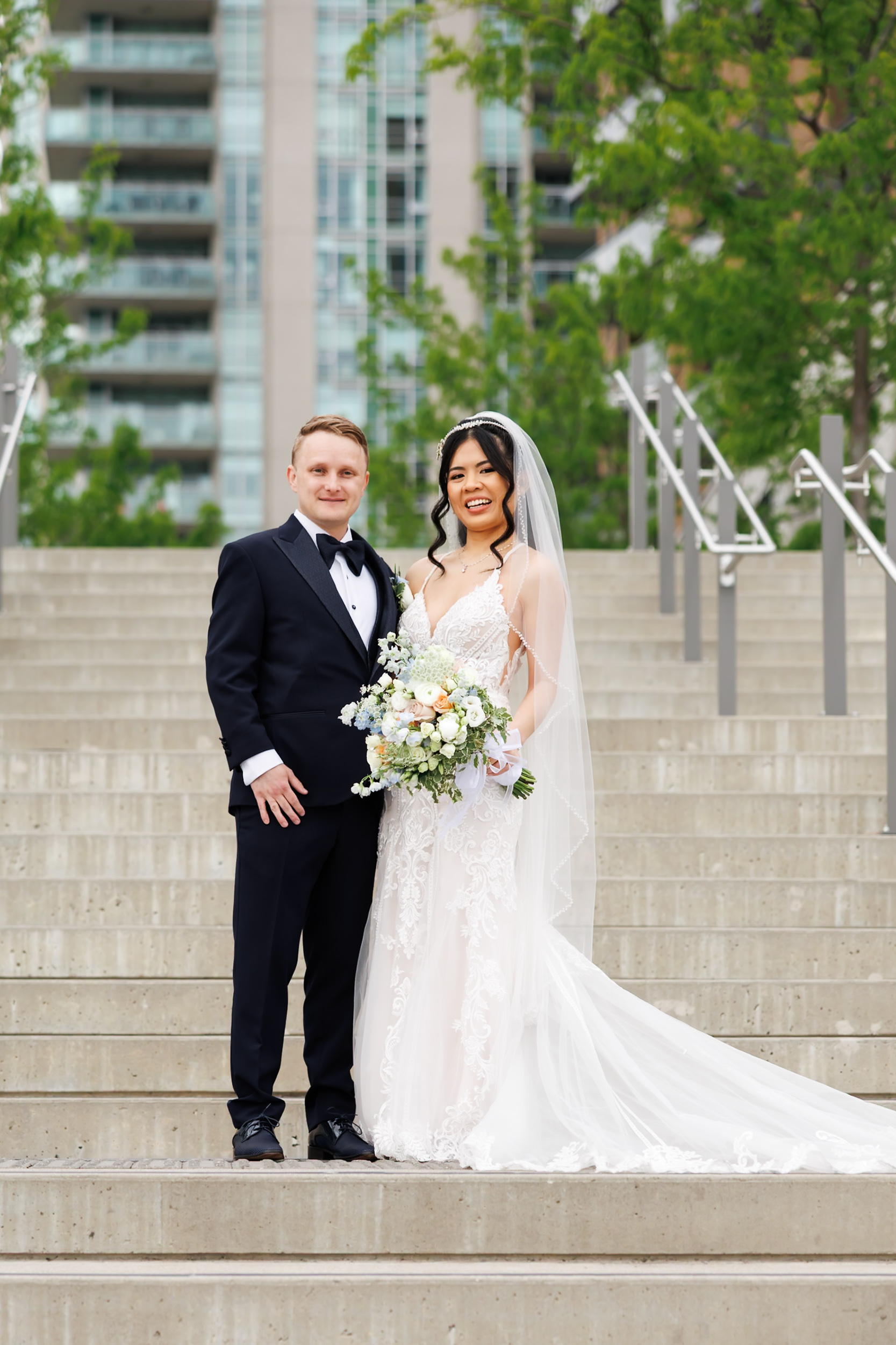 Newlyweds posing on the grand staircase at Pearle Hotel & Spa, Burlington wedding photography.