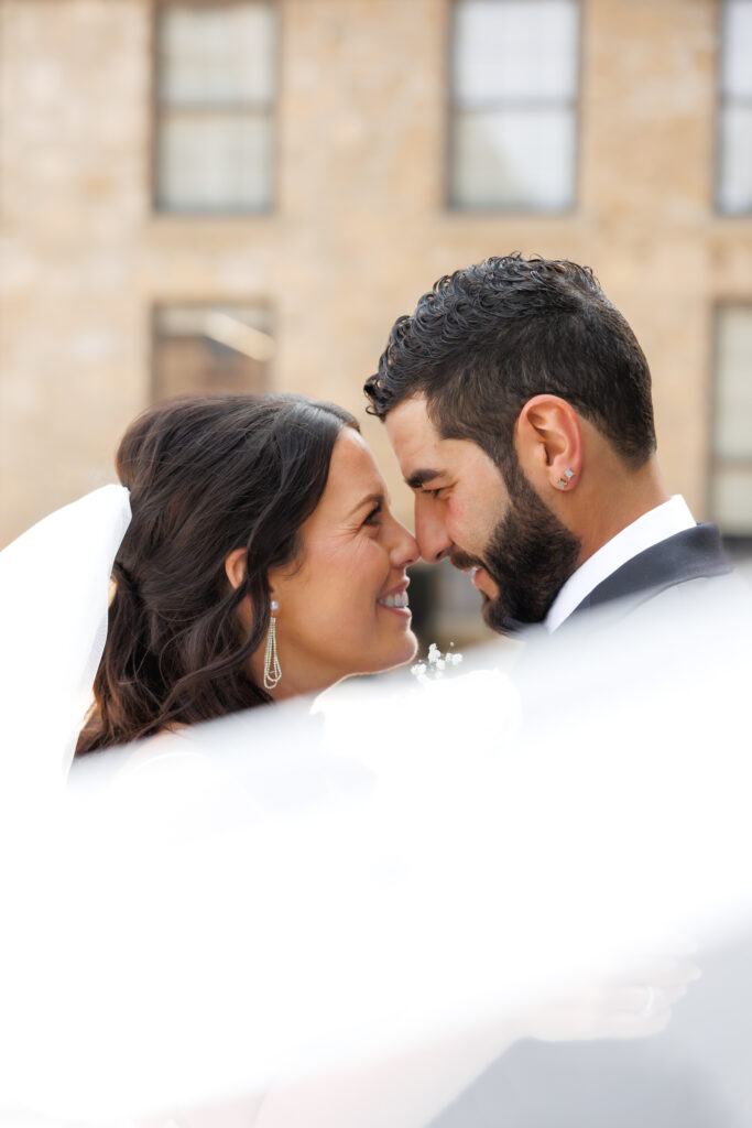 Bride and groom on the stone staircase at Tapestry Hall in Cambridge, editorial wedding portrait.