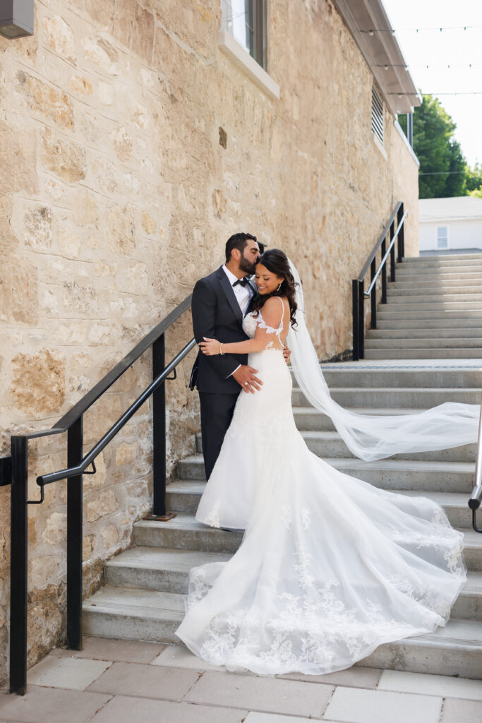 Bride and groom on the stone staircase at Tapestry Hall in Cambridge, editorial wedding portrait.