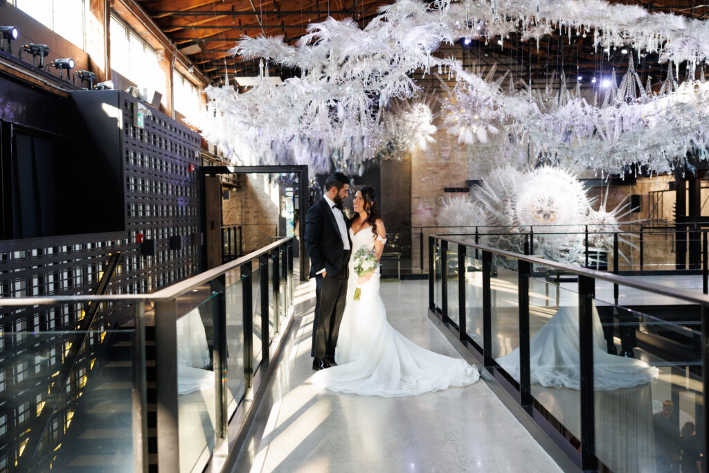 Candid wedding moment under the chandeliers at Tapestry Hall