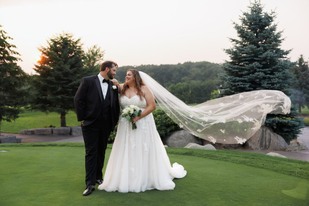 Bride and groom walking at sunset on Whistle Bear golf course wedding venue in Cambridge Ontario, captured by Cambridge wedding photographer Janine Furtado.