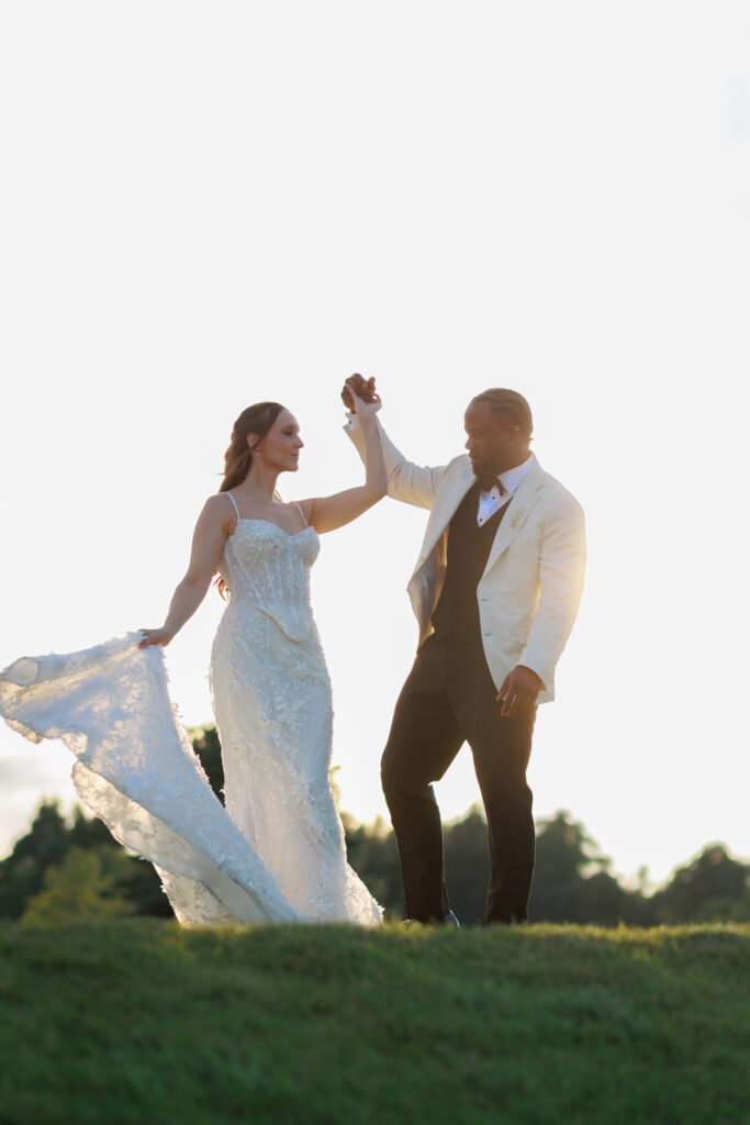 Romantic golden hour wedding photos at Whistle Bear Golf Club in Cambridge, Ontario. Bride and groom dancing on the hill at sunset.