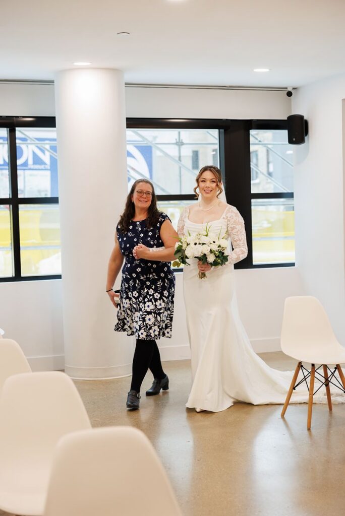 bride walking down isle with mom at dtk chapel wedding
