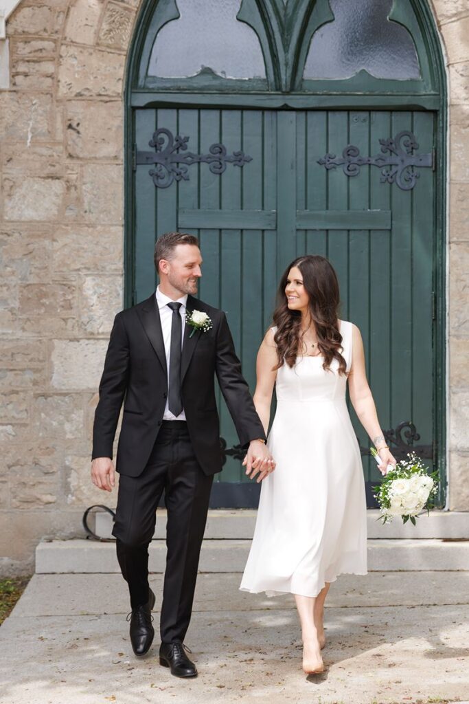 couple walking outside of cambridge city hall after wedding 