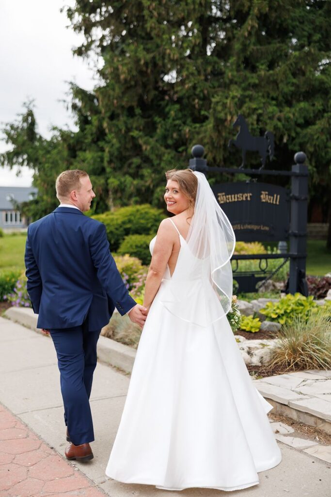 bride looking over shoulder outside of hauser hall 