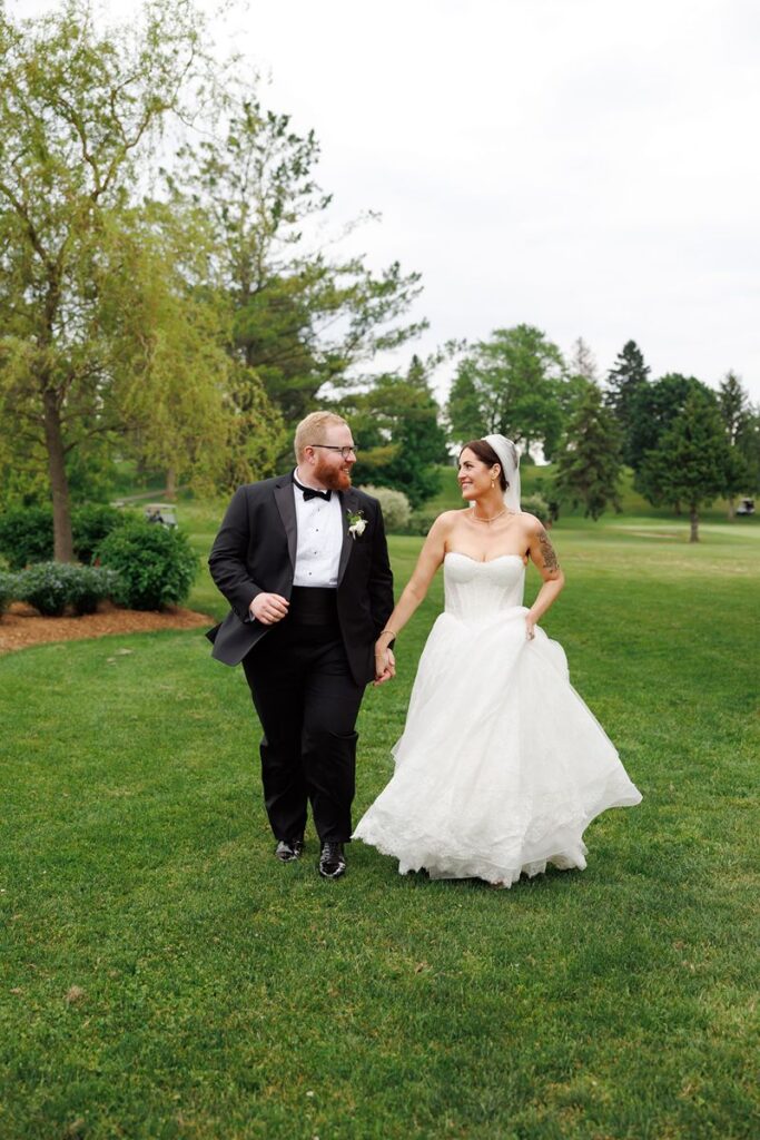 couple running through golf course at st. mary's wedding